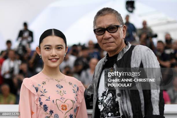 Japanese actress Hana Sugisaki and Japanese director Takashi Miike pose on May 18, 2017 during a photocall for the film 'Blade of the Immortal' at...