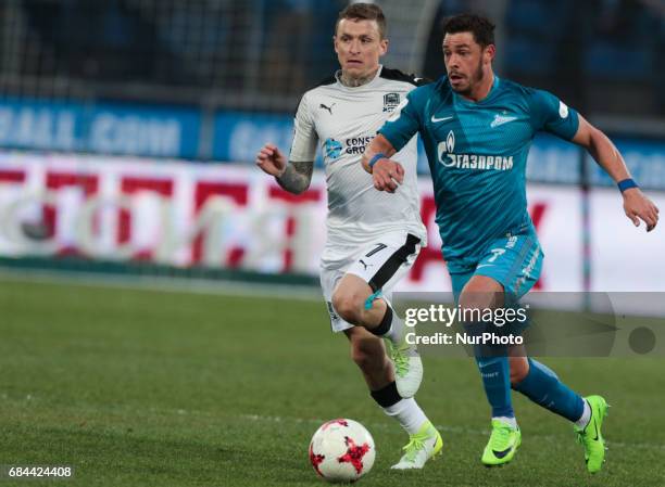 Giuliano of FC Zenit St. Petersburg and Pavel Mamayev of FC Krasnodar vie for the ball during the Russian Football League match between FC Zenit St....