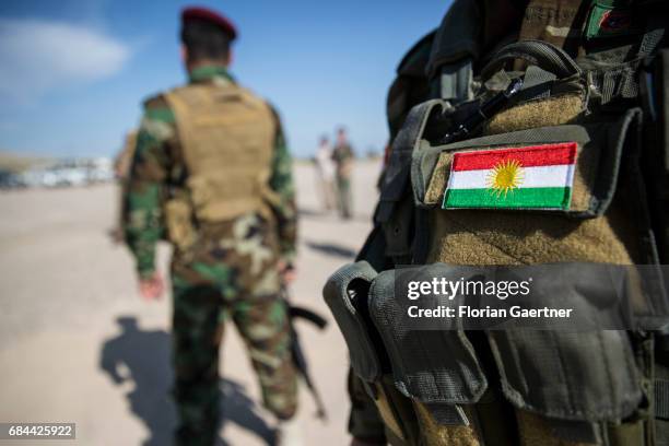 Bashiqa, Iraq National flag of Kurdistan on a uniform of a Kurdish soldier on April 20, 2017 in Bashiqa, Iraq.