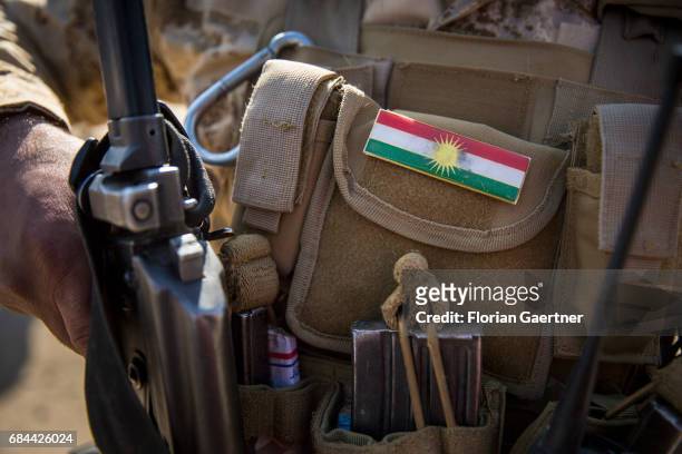 Bashiqa, Iraq National flag of Kurdistan on a uniform of a Kurdish soldier on April 20, 2017 in Bashiqa, Iraq.