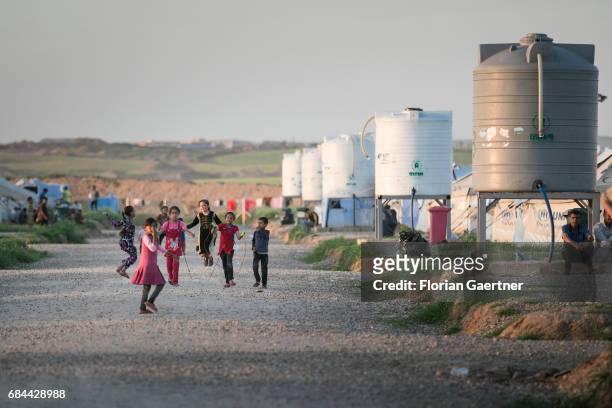 Hasansham, Iraq Children play next to water tanks in the refugee camp 'Hasansham U3' near Hasansham on April 20, 2017 in Hasansham, Iraq.
