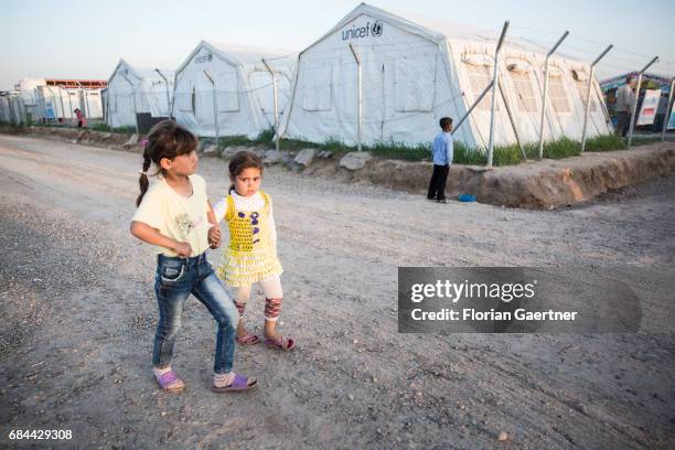 Hasansham, Iraq Children in the refugee camp 'Hasansham U3'. Tents of Unicef are standing in the background on April 20, 2017 in Hasansham, Iraq.