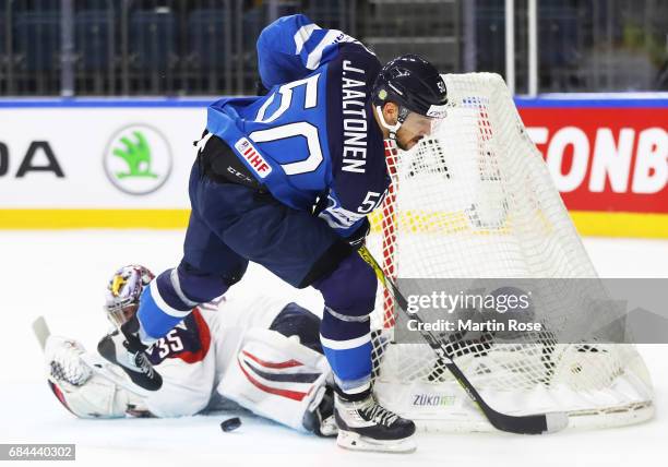 Jimmy Howard of the USA saves a shot by Juhamatti Aaltonen of Finland during the 2017 IIHF Ice Hockey World Championship Quarter Final game between...