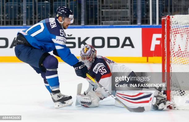 Finland's Juhamatti Aaltonen and USA's Torwart Jimmy Howard vie during the IIHF Men's World Championship Ice Hockey quarter-final match between USA...