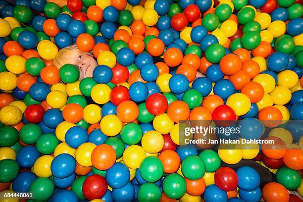 child playing in ball pit - ball pit stock pictures, royalty-free photos & images