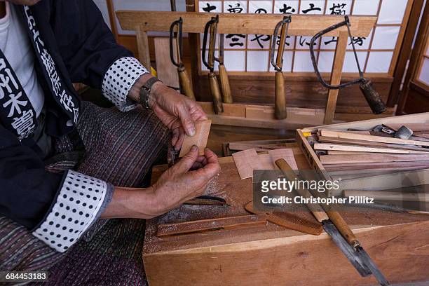Satoshi Kitagawa, 83 year old Comb maker at work in his small studio at the front of his house. He has famously dedicated all his adult life to his...