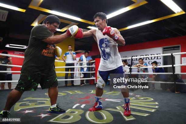 Manny Pacquiao hits the pads with Buboy Buboy Fernandez at Elorde boxing Gym on May 19, 2017 in Manila, Philippines.