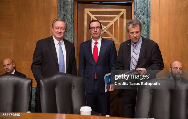 Sen. Sen. Mike Crapo , Treasury Secretary Steven Mnuchin and U.S. Sen. Sherrod Campbell Brown before speaking at a Senate Banking Committee and...