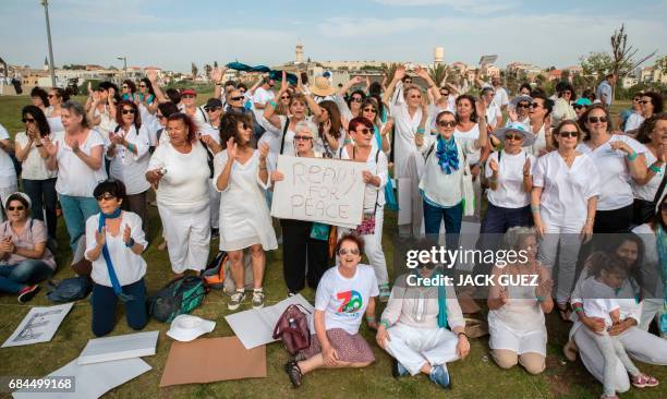 Women from the "Women Wage Peace" group gather in Midoun Park in the Israeli Mediterranean coastal city of Tel Aviv on May 18 in support of the US...