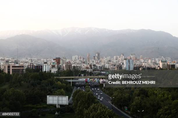 Picture taken on May 18, 2017 shows the skyline of northern Tehran from the "Nature" bridge in the capital Tehran on the eve of the presidential...