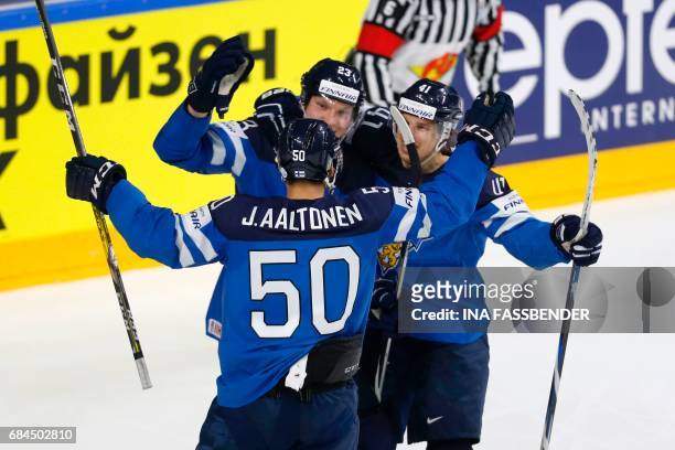 Finland's Juhamatti Aaltonen, Joonas Kemppainen and Antti Pihlstrom celebrate scoring during the IIHF Men's World Championship Ice Hockey...