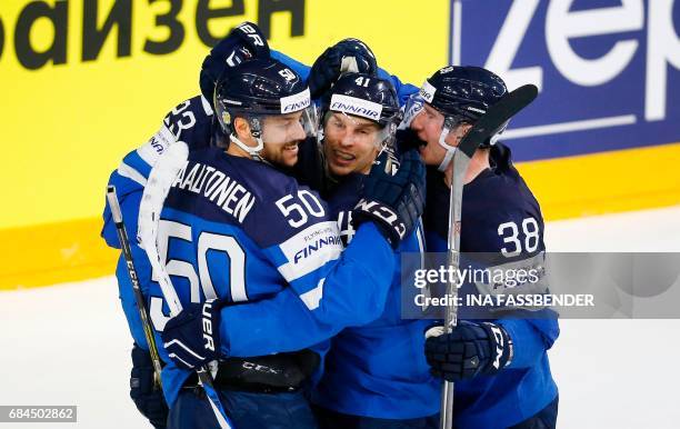 Finland's Juhamatti Aaltonen, Antti Pihlstrom and Juuso Hietanen celebrate scoring during the IIHF Men's World Championship Ice Hockey quarter-final...