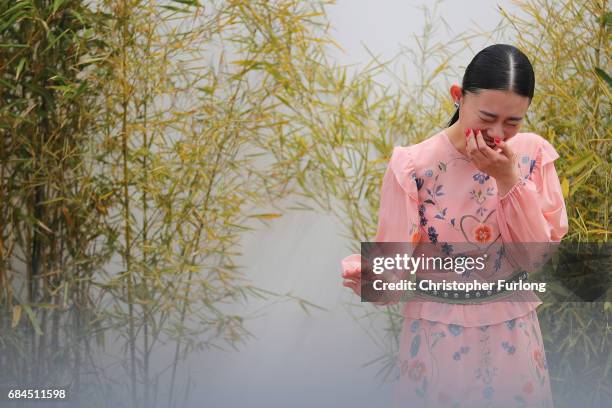 Actress Hanna Sugisaki shyly giggles as she arrives to attend the 'Blade Of The Immortal ' press conference on the Boulevard de la Croisette during...