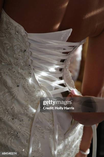 lacing up the back of a wedding dress - lace fastener bildbanksfoton och bilder