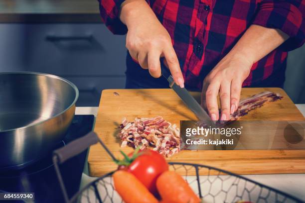 young woman cooking at home - pancetta stock pictures, royalty-free photos & images