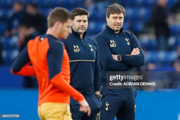 Tottenham Hotspur's Argentinian head coach Mauricio Pochettino and first team coach Miguel D'Agostino watch players warm up ahead of the English...