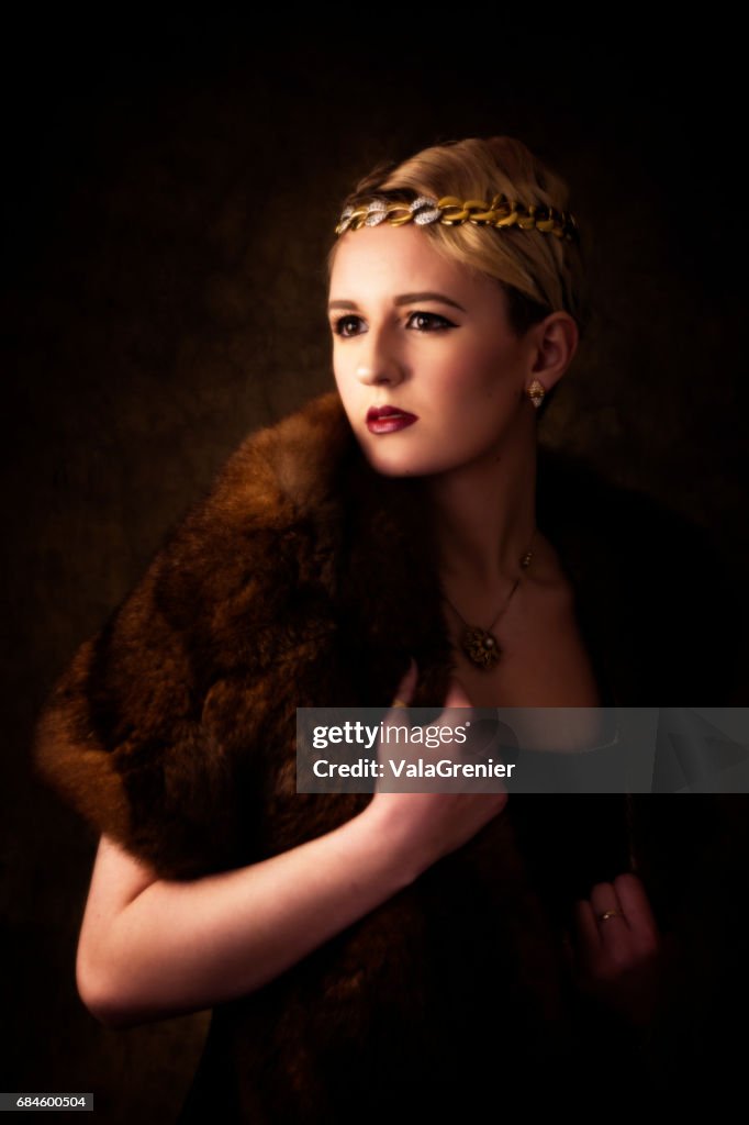Elegant young blonde woman in fur and head band.