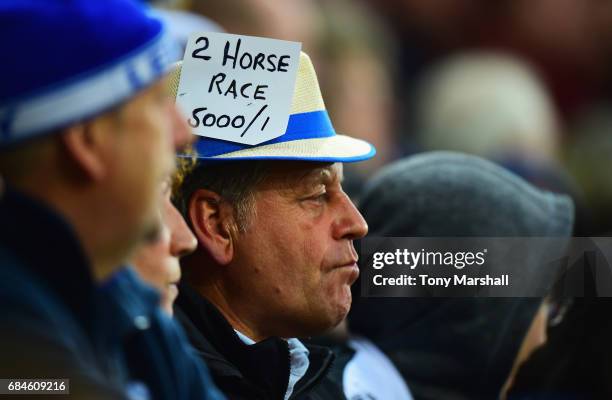 Leicester City fan sports a badge reading '2 horse race 5000/1' during the Premier League match between Leicester City and Tottenham Hotspur at The...