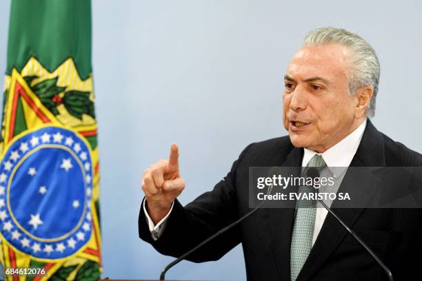 Brazil's President Michel Temer speaks during a press conference following allegations that he gave his blessing to payment of hush money to a...
