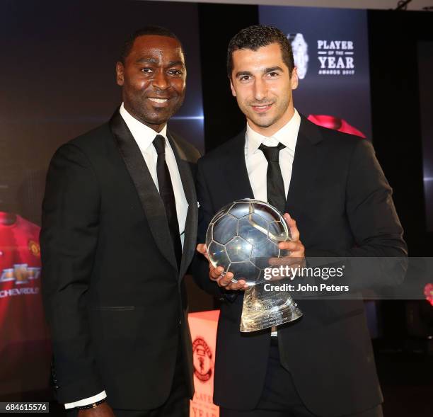 Henrikh Mkhitaryan of Manchester United is presented with the Goal of the Year award for his goal against Sunderland by former player Andy Cole at...