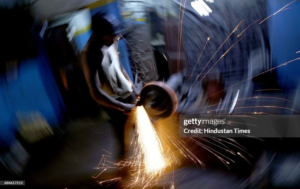 Gun Factory A worker giving a shape to the barrels of a gun at a gun factory on ...