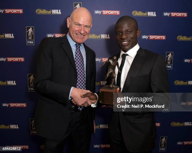 Chelsea Midfielder N'Golo Kante is presented with the FWA Player of the Year Award by Football Writers Association Chairman Patrick Barclay, at The...