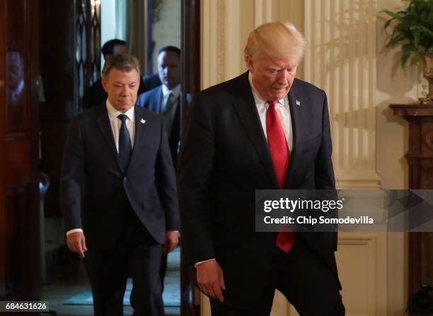 President Donald Trump and Colombian President Juan Manuel Santos walk up to the podiums to hold a joint news conference at the White House May 18,...
