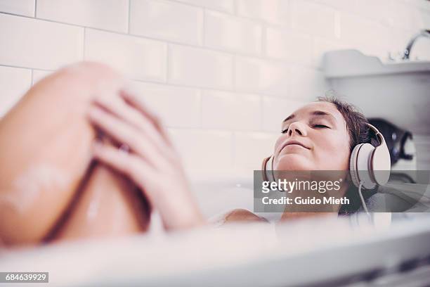 woman enjoying a bath. - indulgence foto e immagini stock