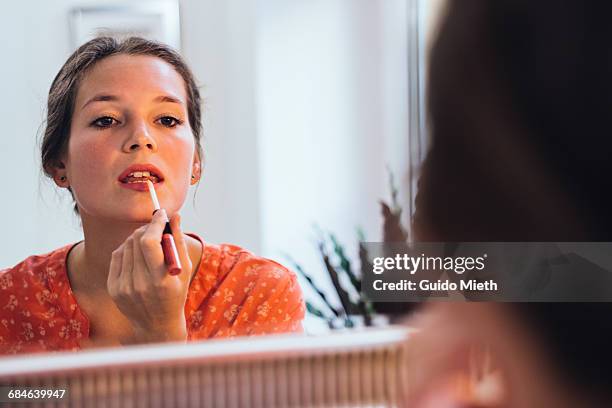 woman applying lipstick. - applying make up stockfoto's en -beelden