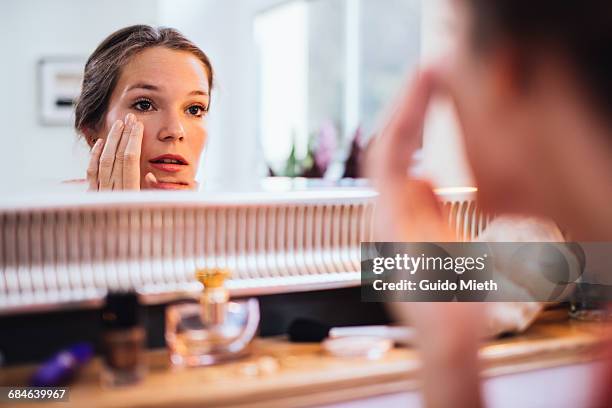 woman applying makeup. - makeup mirror stock pictures, royalty-free photos & images