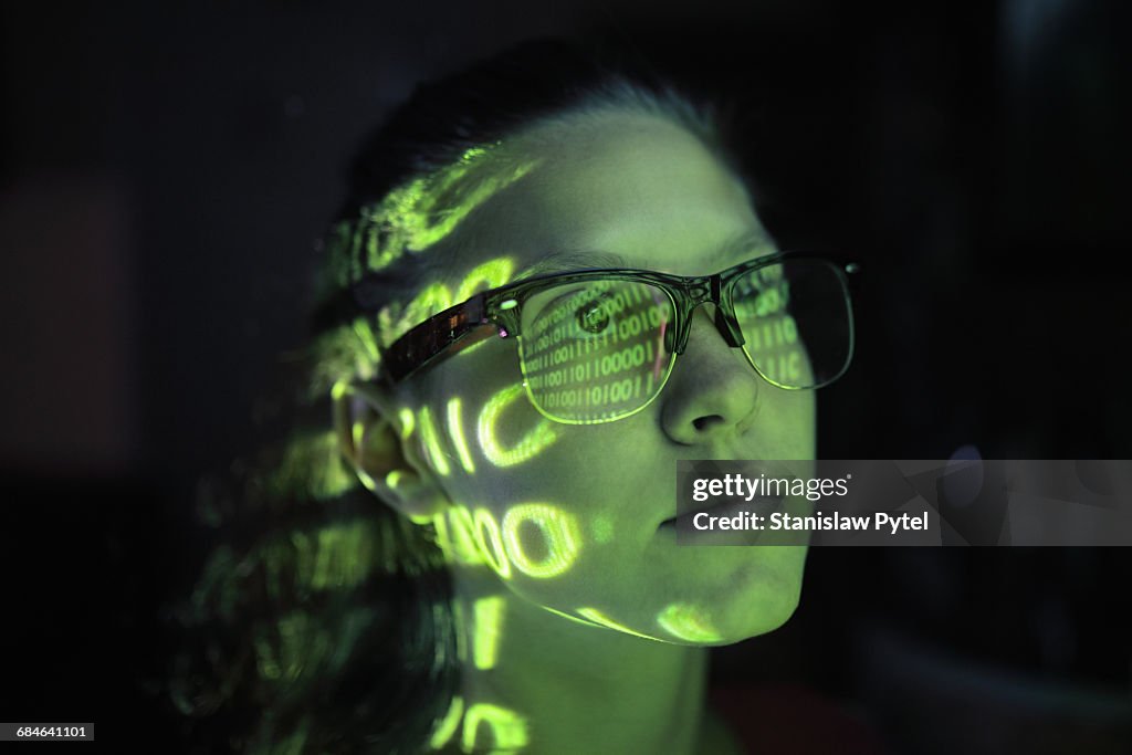 Portrait of girl lighted with green numbers