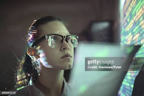 woman looking at wall with code - informatik stock-fotos und bilder