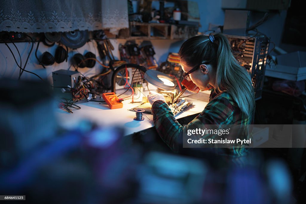 Woman soldering in workshop