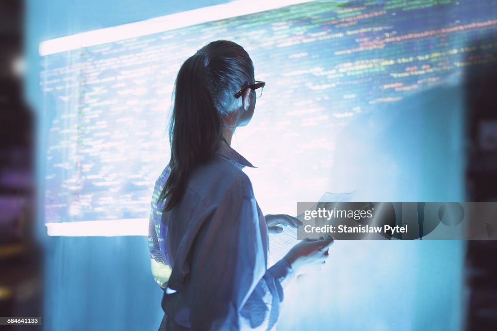 Woman looking at wall with code