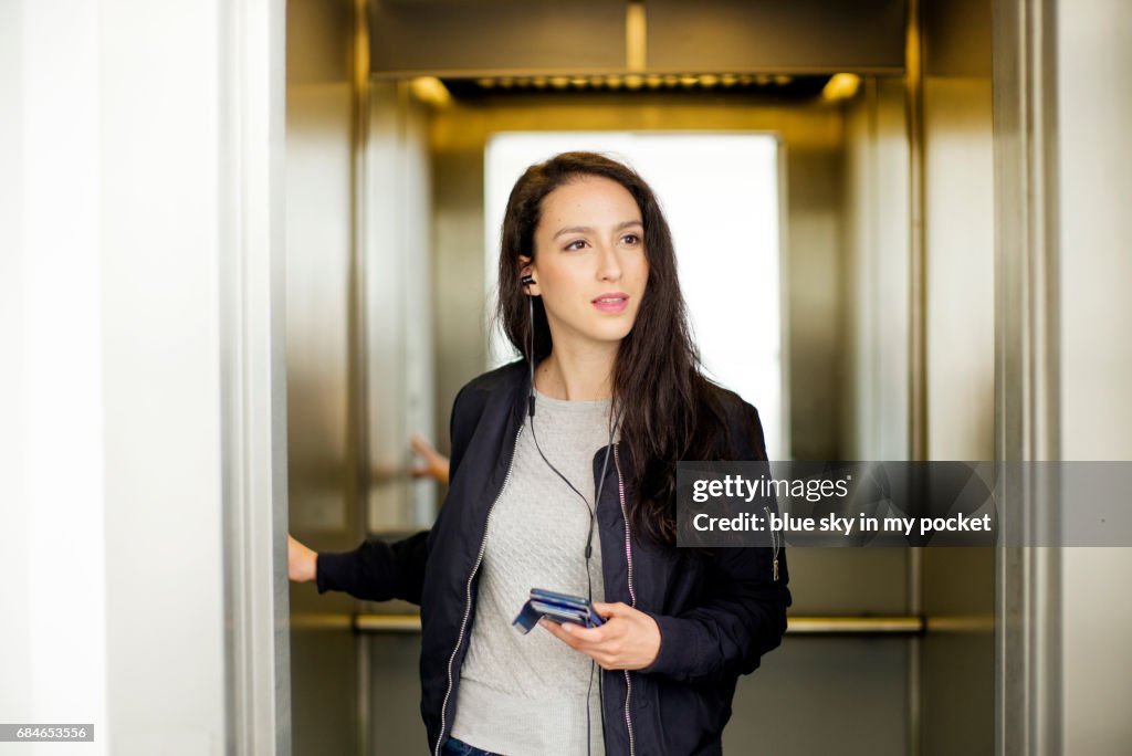 A young woman listening to a podcast.