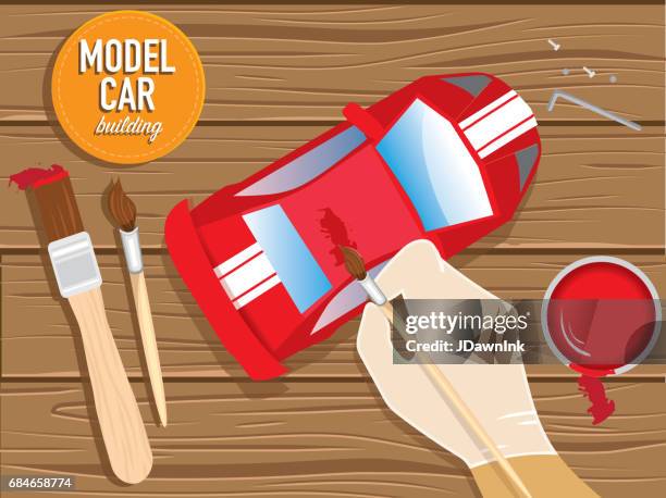 model car hobbyist concept with hand and paintbrush - car model stock illustrations