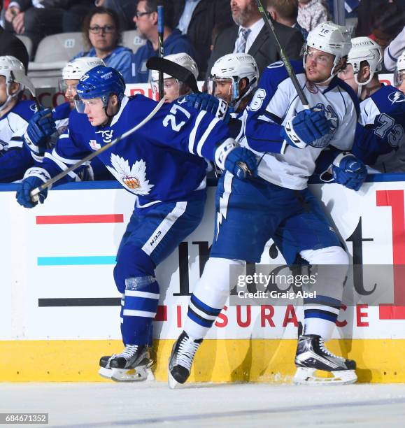 Carl Grundstrom of the Toronto Marlies collides with Tye McGinn of the Syracuse Crunch during game 6 action in the Division Final of the Calder Cup...