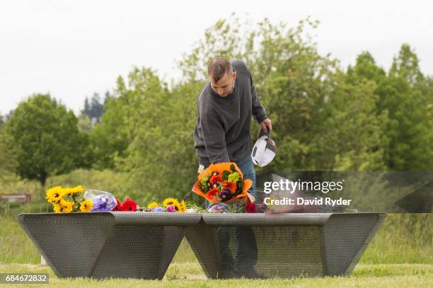 Steele Granger leaves flowers on a makeshift memorial for Chris Cornell at A Sound Garden, the sculpture that inspired the name of the band...