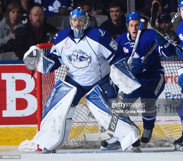 Mike McKenna of the Syracuse Crunch and Rich Clune of the Toronto Marlies prepare for a shot during game 6 action in the Division Final of the Calder...