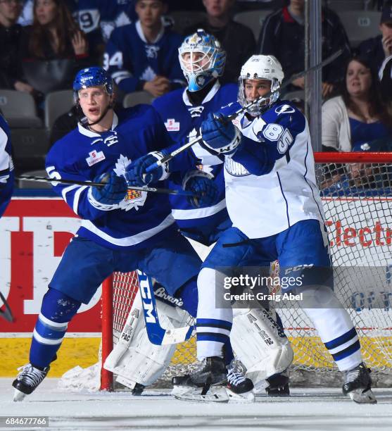 Steven Oleksy and goalie Kasimir Kaskisuo of the Toronto Marlies fight for crease space with Daniel Walcott of the Syracuse Crunch during game 6...