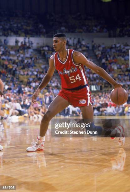 Charles Smith of the Los Angeles Clippers dribbles the ball during the NBA game against the Los Angeles Lakers at the Great Western Forum, in Los...