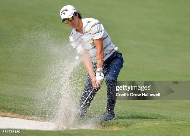 Ryo Ishikawa of Japan hits a bunker shot on the 11th hole during Round One of the AT&T Byron Nelson at the TPC Four Seasons Resort Las Colinas on May...