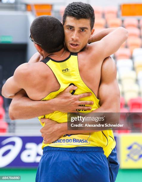 Alvaro Filho and Saymon of Brazil celebrate a point during the main draw match against France at Parque Olimpico during day one of the FIVB Beach...