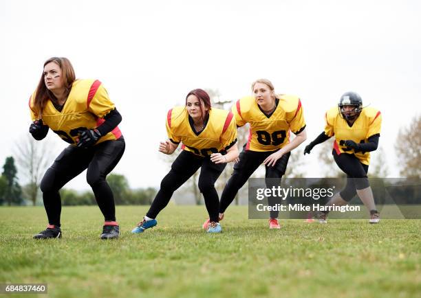 female american football team warming up - safety american football player stock pictures, royalty-free photos & images