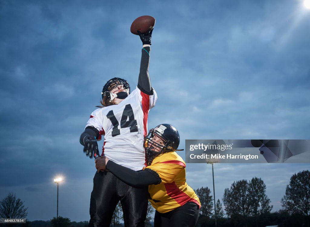 Sportswoman jumping to reach for ball