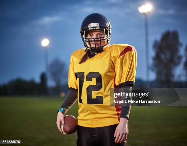 portrait of female american footballer in evening light - safety american football player stock pictures, royalty-free photos & images