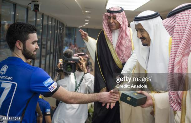 Saudi Arabia's King Salman bin Abdulaziz Al Saud celebrates El Hilal players after the Saudi King's Cup final match between El Hilal and Al Ahli at...