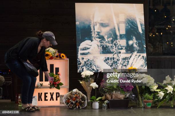 Woman leaves flowers on stage during a memorial for musician Chris Cornell at the KEXP radio studio on May 18, 2017 in Seattle, Washington. Cornell,...