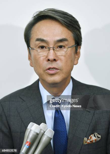 Nobuteru Ishihara, Japan's minister in charge of revitalizing the economy, speaks to reporters at Tokyo's Haneda airport on May 19 before leaving for...