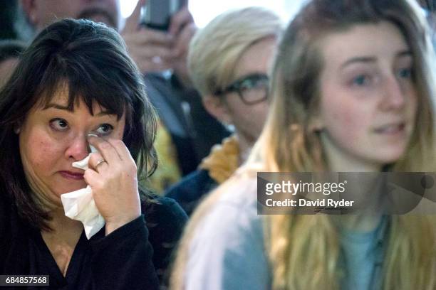 Woman wipes away tears during a memorial for musician Chris Cornell at the KEXP radio studio on May 18, 2017 in Seattle, Washington. Musician Chris...